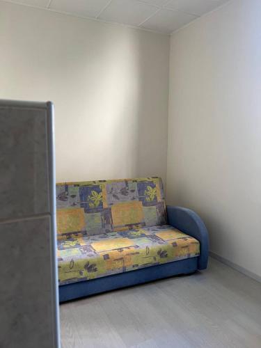 a couch sitting in a corner of a room at Vienibas prospekts in Jūrmala