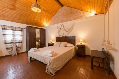 a bedroom with a bed and a wooden ceiling at The old town Neighbourhood in Rhodes Town