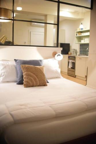 a large white bed with a pillow on it at Annabelle 2A - Studio In The Heart Of Night Life in Savannah