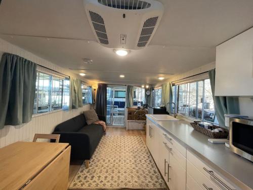a kitchen and living room of an rv at The Albatross-Houseboat DT Knox in Knoxville