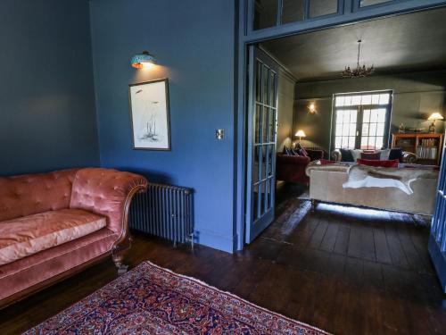 a living room with a couch and a table at The Retreat at Glanrannell Park House in Llanwrda