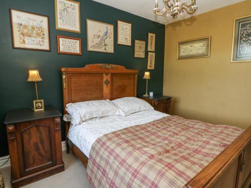 a bedroom with a bed with a checkered blanket at The Retreat at Glanrannell Park House in Llanwrda