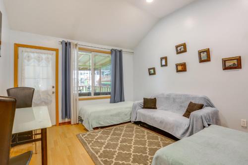 a living room with a couch and a window at 6 Mi to Bethel Woods Cabin with Pool Access in Mongaup Valley