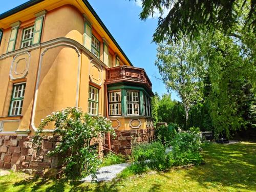 a building with a large window on the side of it at Vila Mezi Časy in Trutnov