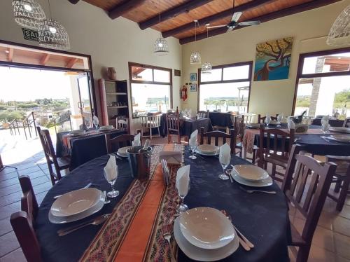 a dining room with a long table and chairs at Altos de Amaicha Posada Boutique in Amaicha del Valle