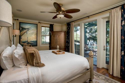 a bedroom with a bed with a ceiling fan at Montage Palmetto Bluff in Bluffton