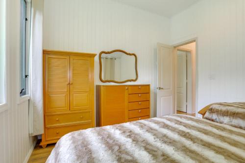 a bedroom with a bed and a dresser and a mirror at 6 Mi to State Park Mongaup Valley Cabin! in Mongaup Valley