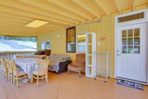 a room with a table and chairs on a porch at 6 Mi to State Park Mongaup Valley Cabin! in Mongaup Valley