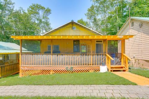 a yellow house with a porch and a porch at 6 Mi to State Park Mongaup Valley Cabin! in Mongaup Valley