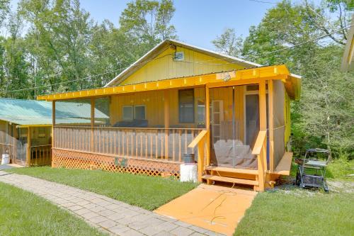 a small yellow house with a large front porch at 6 Mi to State Park Mongaup Valley Cabin! in Mongaup Valley
