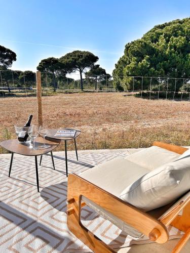 a patio with a couch and a table and a field at Meco Lodge Deep Blue in Sesimbra
