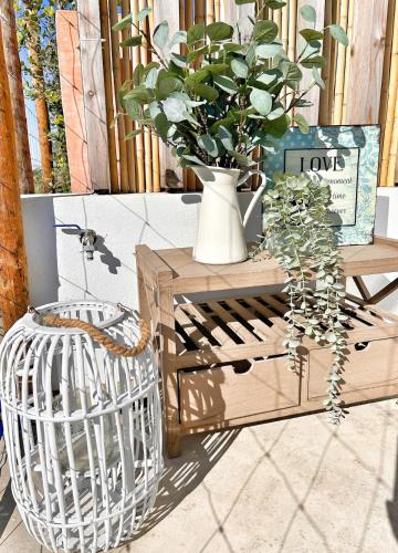 a table with a vase with a plant on it at Meco Lodge Deep Blue in Sesimbra