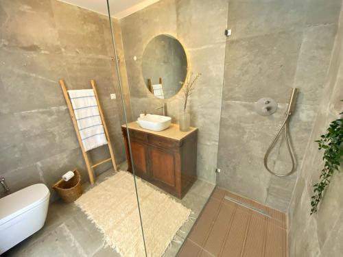 a bathroom with a shower and a sink and a mirror at Meco Lodge Deep Blue in Sesimbra