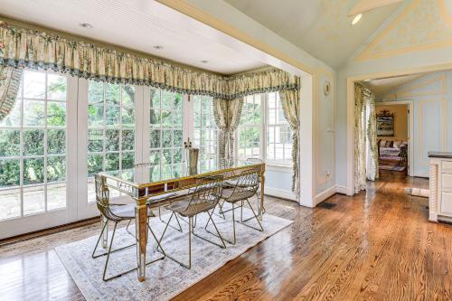 a dining room with a glass table and chairs at 16 Mi to Baltimore Spacious Home in Owings Mills! in Owings Mills