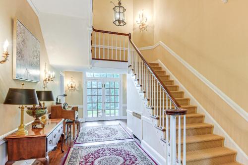 a staircase in a home with a rug at 16 Mi to Baltimore Spacious Home in Owings Mills! in Owings Mills