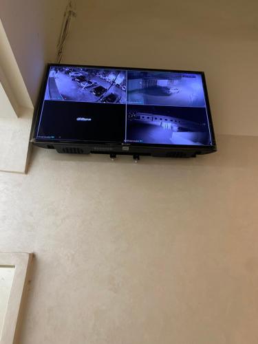 a flat screen tv hanging on a wall at Appartement sur tanger - pour vacance in Tangier