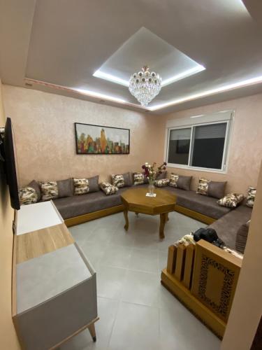 a living room with a couch and a table at Appartement sur tanger - pour vacance in Tangier
