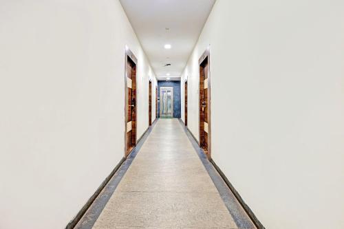 an empty corridor in a building with a door at Super Collection O Vizag International Cricket Stadium in Visakhapatnam