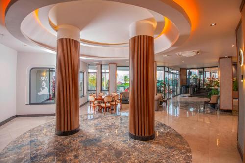 a lobby of a building with columns at Class Unique Beach in Marmaris