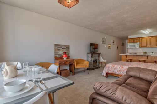 a bedroom with a bed and a kitchen with a table at Sea Gypsy Rentals - Oceanfront Suite - Top Floor in Lincoln City