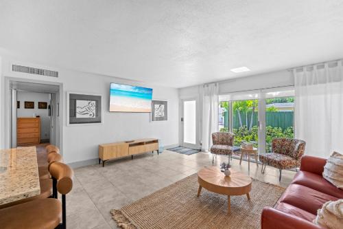 a living room with a couch and a table at The Olives at Prospect Park in West Palm Beach