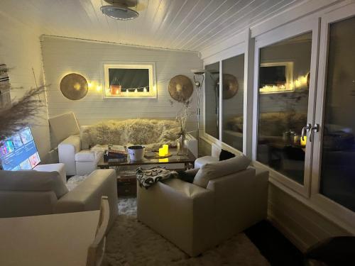 a living room with two couches and a table at Swedish idyll, alp around the corner! in Tallåsen