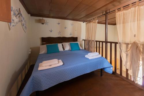 a bedroom with a blue bed with towels on it at The old town Neighbourhood in Rhodes Town
