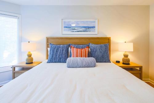 a bedroom with a white bed with two lamps at Lazy Lagoon in Kiawah Island