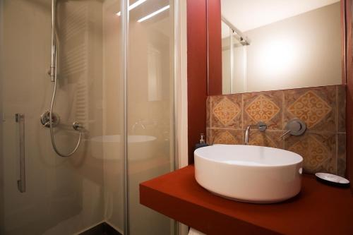 a bathroom with a white sink and a shower at Palazzo Mirelli in Naples