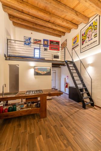 a large room with a staircase in the ceiling at Palazzo D'Alessandro Wunderkammer & Suites B&B di charme in Caporciano