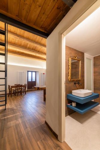 a bathroom with a sink and a mirror on the wall at Palazzo D'Alessandro Wunderkammer & Suites B&B di charme in Caporciano