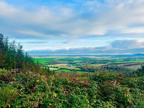 a view of a field from the top of a hill at Cobblers Walk - Luxury Country Getaway 