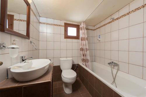 a bathroom with a sink and a toilet and a tub at The old town Neighbourhood in Rhodes Town