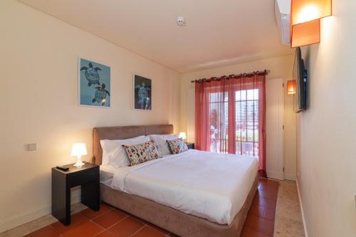 a bedroom with a bed and a window at Vilamoura Marina Lake in Vilamoura