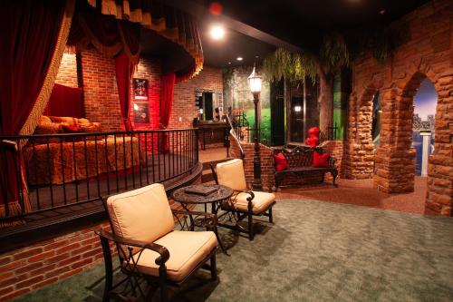 a bar with chairs and a table and a brick wall at Destinations Inn Theme Rooms in Idaho Falls