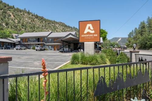 a sign for a mountain inn with a parking lot at Adventure Inn Durango in Durango