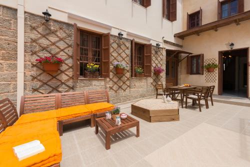 an outdoor patio with a couch and a table at The old town Neighbourhood in Rhodes Town