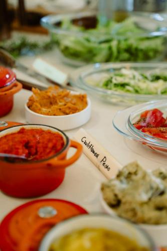 a table with plates of food and bowls of food at Mahakala Center in Petrovac na Moru