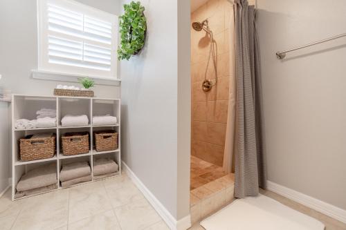 a bathroom with a walk in shower next to a shower at Cottage on Hughes in Fayetteville
