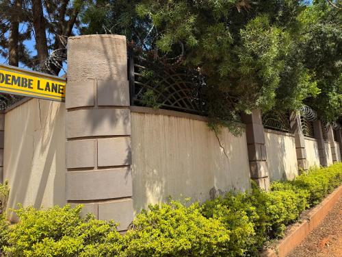 a concrete fence with a sign on top of it at Kampala Comfort 1 in Nalakonge