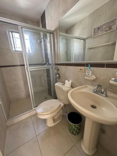 a bathroom with a toilet and a shower and a sink at Casa frente a la playa con vista al mar in Vacamonte