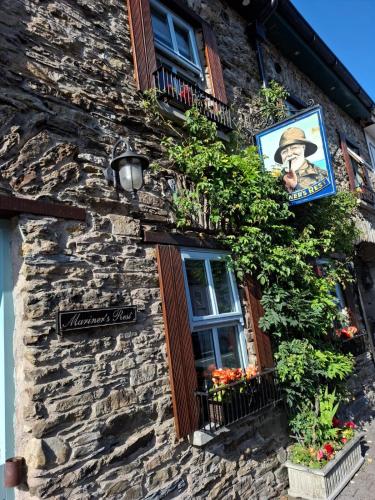 a building with a window and a sign on it at Mariners Rest One Bedroom Apartment in Innishannon Village in Cork