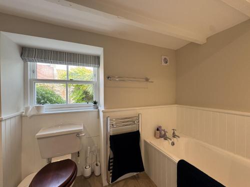 a bathroom with a tub and a toilet and a sink at Crab Shack, Crail in Crail