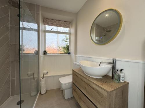 a bathroom with a sink and a toilet and a mirror at Crab Shack, Crail in Crail