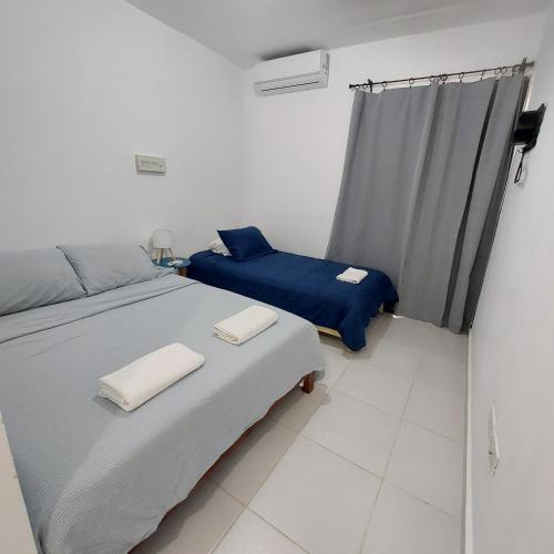 Ένα ή περισσότερα κρεβάτια σε δωμάτιο στο Santo Domingo Este