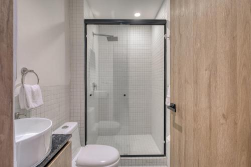 a bathroom with a shower with a toilet and a sink at Myla Chapultepec in Mexico City