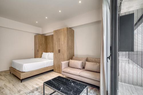 a small bedroom with a bed and a couch at Myla Chapultepec in Mexico City