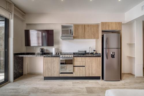 a kitchen with a stainless steel refrigerator at Myla Chapultepec in Mexico City