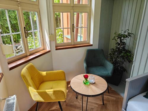 a living room with two chairs and a table at Vila Mezi Časy in Trutnov