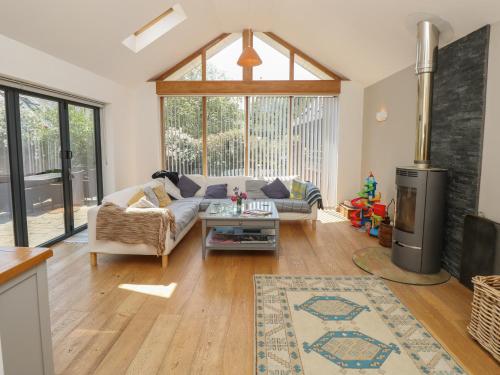 a living room with a couch and a table at Guildford Farmhouse in Ryde